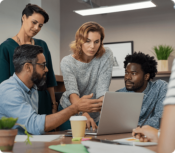 Team collaborating around a laptop